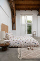 SNURK Bird Watching dekbedovertrek op een bed in een moderne slaapkamer met houten details.