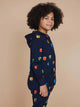 Kind in SNURK Building Blocks Onesie Kids met kleurrijke blokken op een donkerblauwe achtergrond.