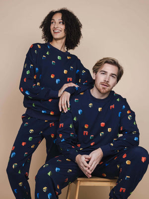 SNURK Building Blocks Sweater Unisex worn by models, featuring colorful blocks on a navy background.