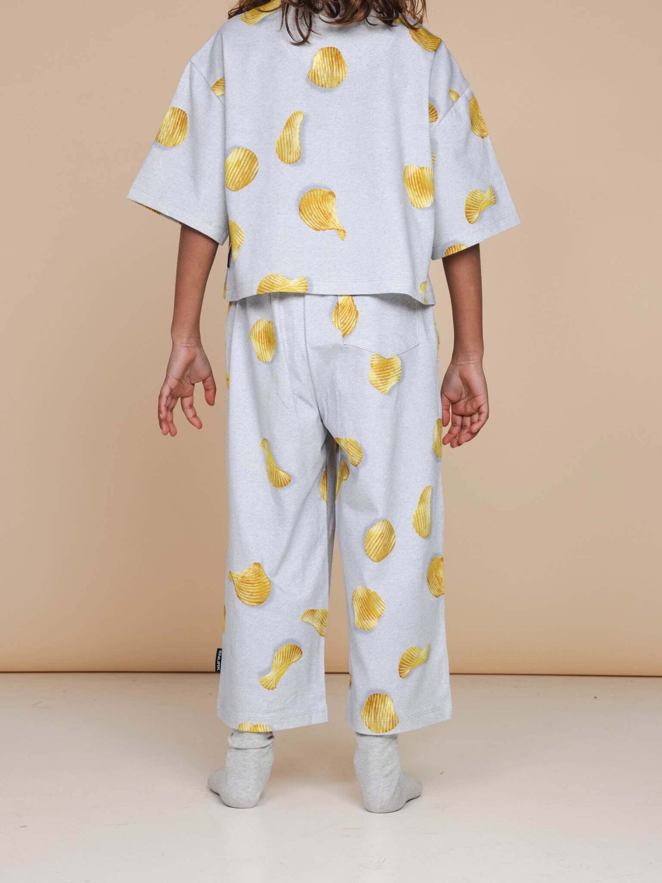 SNURK Chips Cropped T-Shirt Kids in a playful yellow chip print, perfect for kids' loungewear.