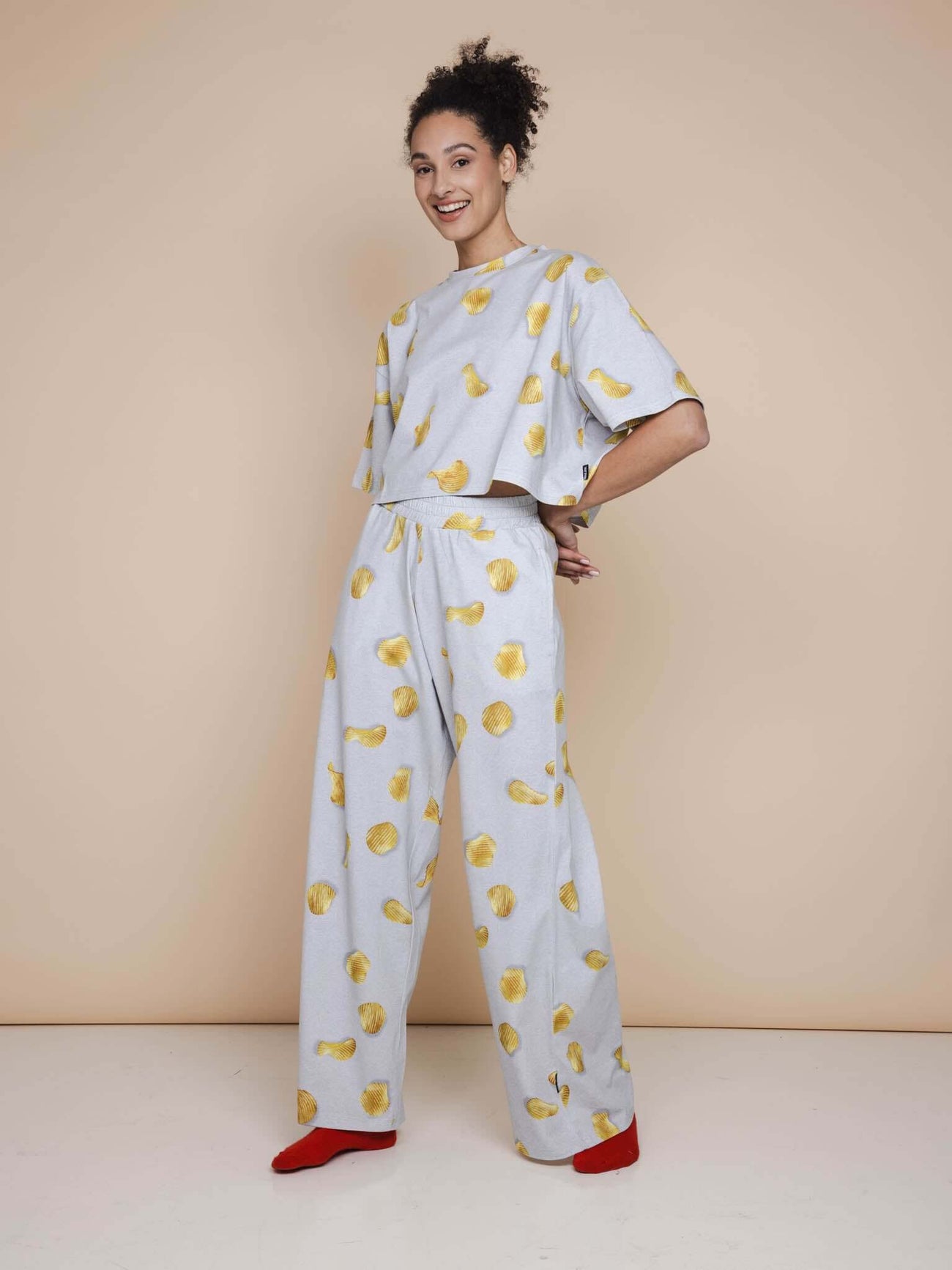 SNURK Chips Cropped T-shirt Dames met all-over print van chips op lichtgrijze achtergrond en comfortabele fit.