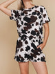 Vrouw in SNURK Cow Shorts Dames met koeienhuidprint, perfect voor loungen of slapen.