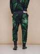 SNURK Dark Forest Broek Regular Unisex met grote donkergroene bladeren op een antracietgrijze achtergrond.
