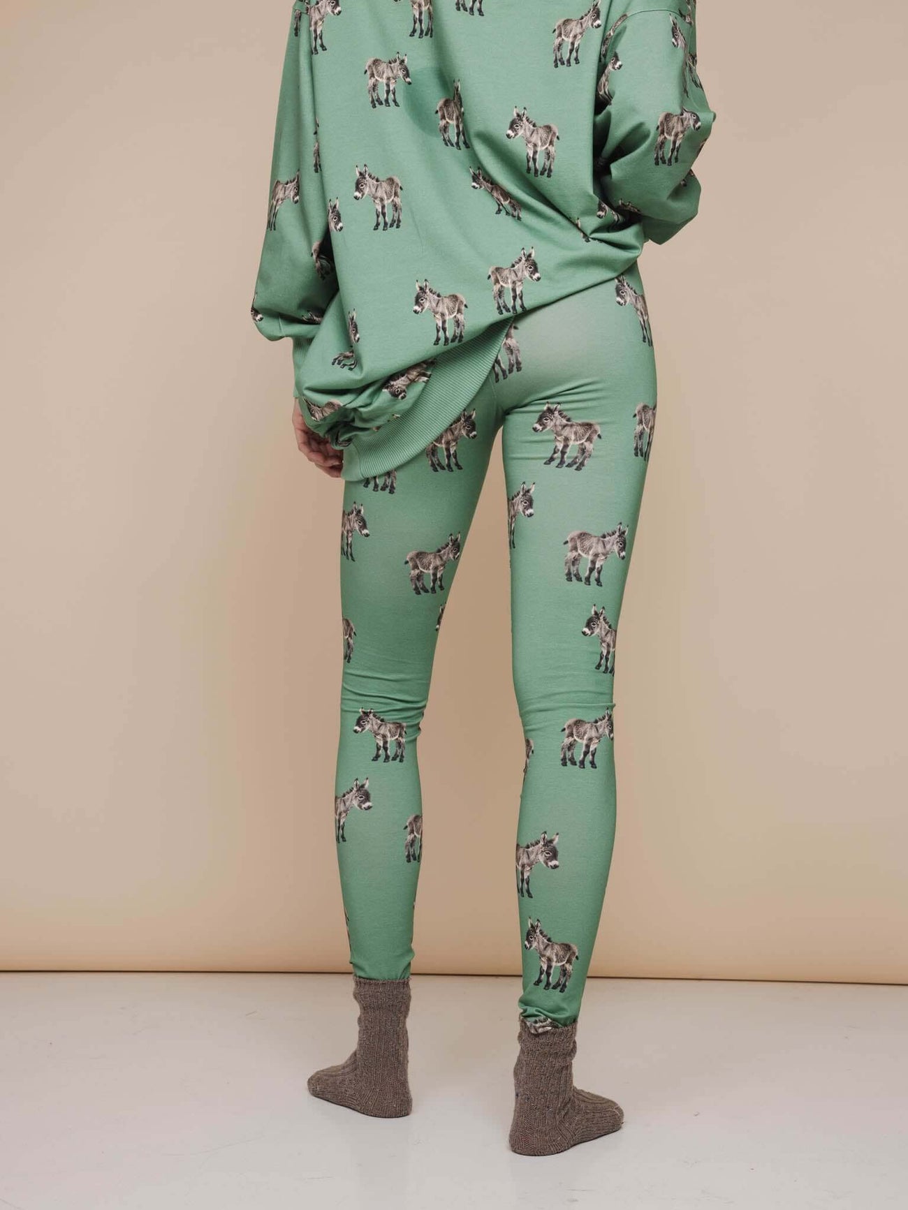 SNURK Donkeys Legging Dames vrouwelijke legging met schattige baby-ezels op een zachtgroene achtergrond.