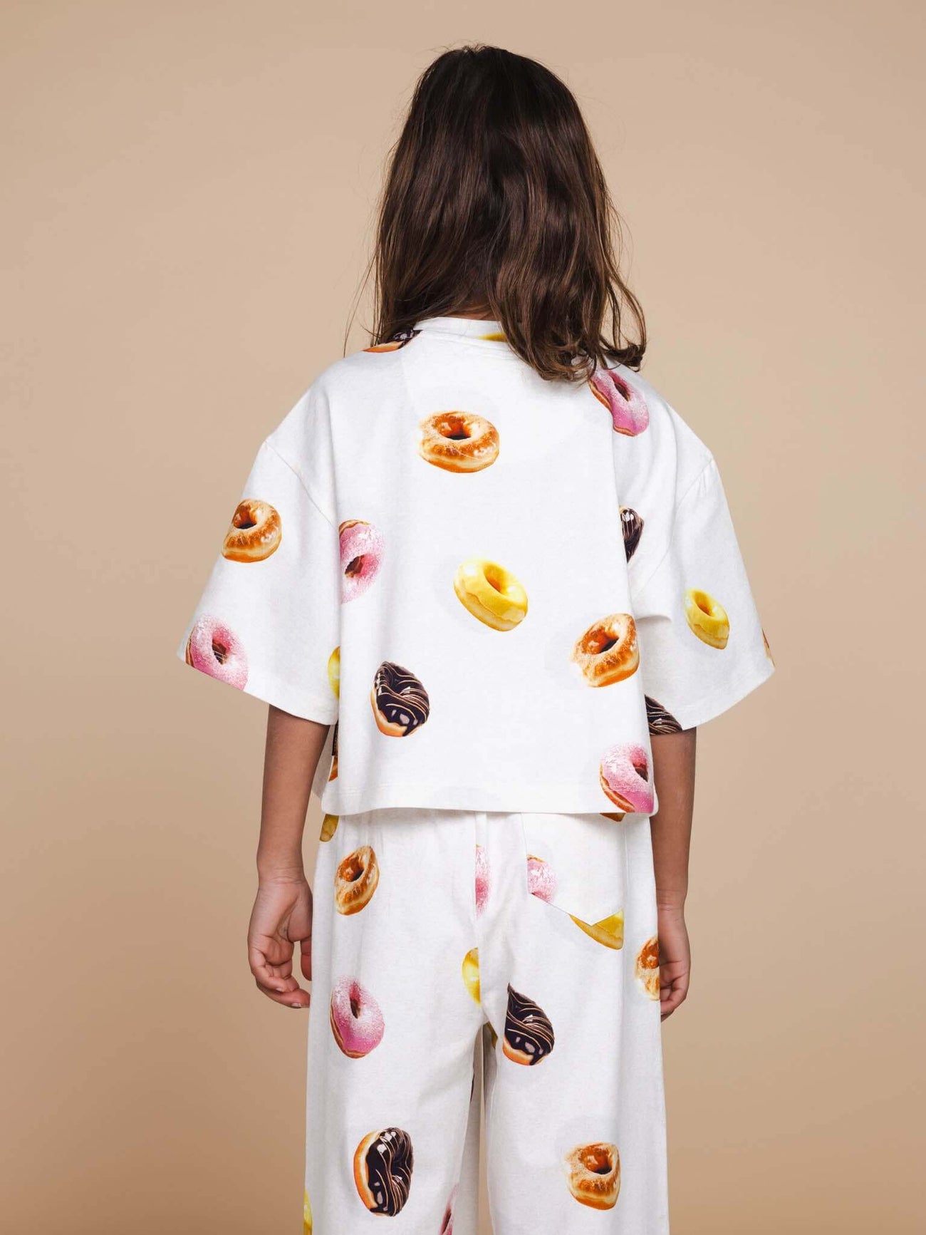 SNURK Donuts Cropped T-Shirt Kids in wit met kleurrijke donutprint, ideaal voor kinderen, gezien van achteren.