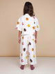 A girl wearing the SNURK Donuts Cropped T-Shirt Kids, showcasing a vibrant donut print in a cropped fit.