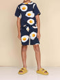 SNURK Eggs Navy Shorts Kids model in comfy outfit with egg print, ideal for boys and girls, made of organic cotton.