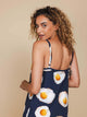 SNURK Eggs Navy Strap Dress Dames model met spaghettibandjes, achterkant en eierenprint voor een zomerse look