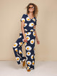 Vrouw in SNURK Eggs Navy V-Neck T-shirt Dames met spiegeleitjesprint in relaxte outfit.
