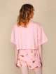 SNURK Ice Cream Cone Cropped T-Shirt Dames van achteren gezien, roze T-shirt met ijsje op een roze achtergrond.