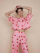 SNURK Lollipop Love Cropped T-shirt Dames model in roze shirt met hartjeslollies.