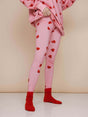 SNURK Lollipop Love Legging Dames met felrode hartjeslollies op roze achtergrond.