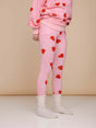 SNURK Lollipop Love Legging Kids met felrode hartjeslollies op roze achtergrond voor een vrolijke look.
