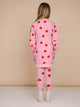 Meisje in roze SNURK Lollipop Love Legging Kids met hartjeslollies print, gezien van achteren.