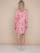 SNURK Lollipop Love Long Sleeve Dress Dames in pink with red heart lollies, viewed from the back.