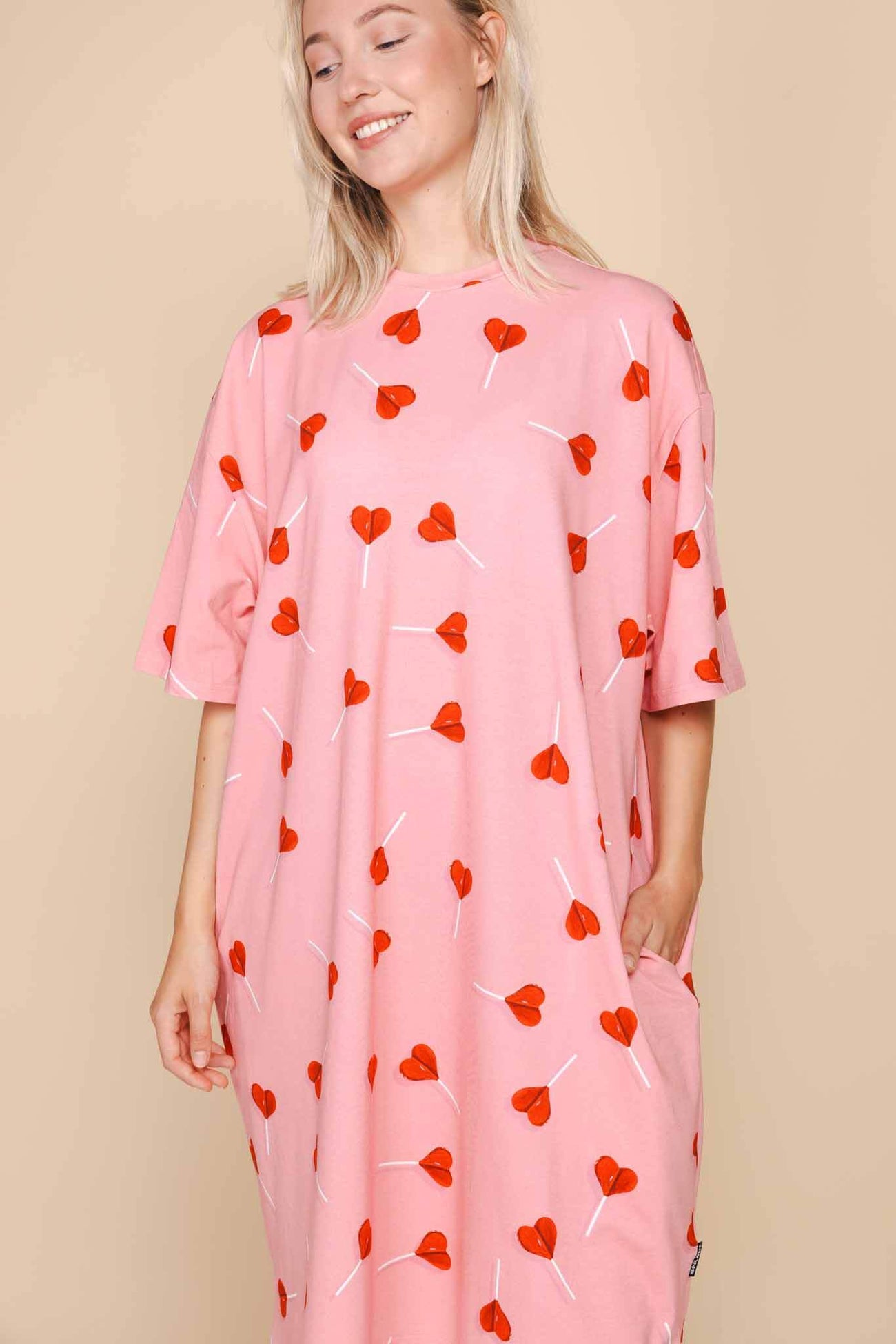 SNURK Lollipop Love Relaxed Tee Dress Dames met felrode hartjes op roze achtergrond, losse fit en zakken.