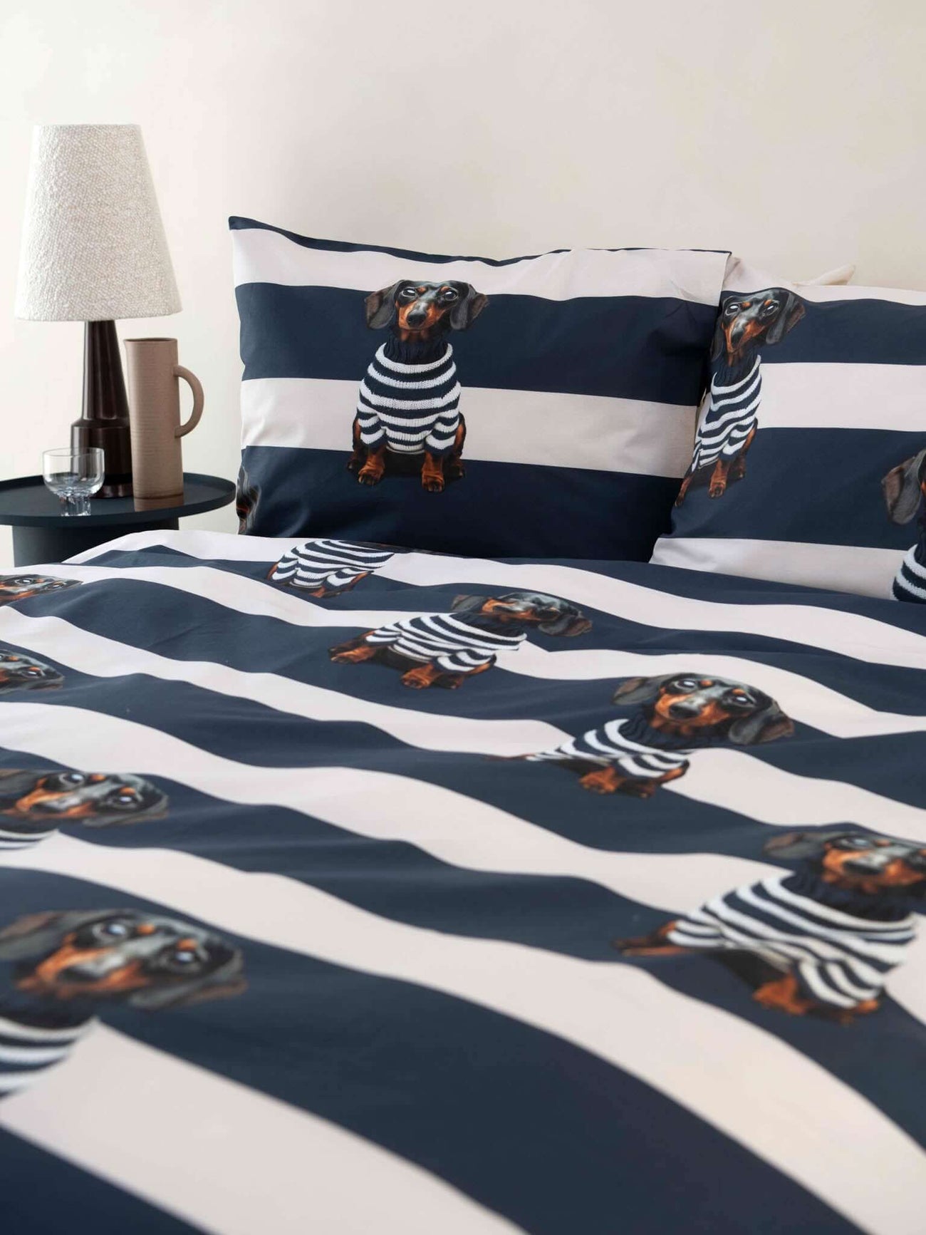 SNURK Pierre dekbedovertrek met gestreepte print en vrolijke teckelontwerpen op bed