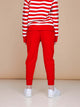 A child wearing SNURK Red Broek Kids joggingbroek with a striped shirt, showcasing the back view.