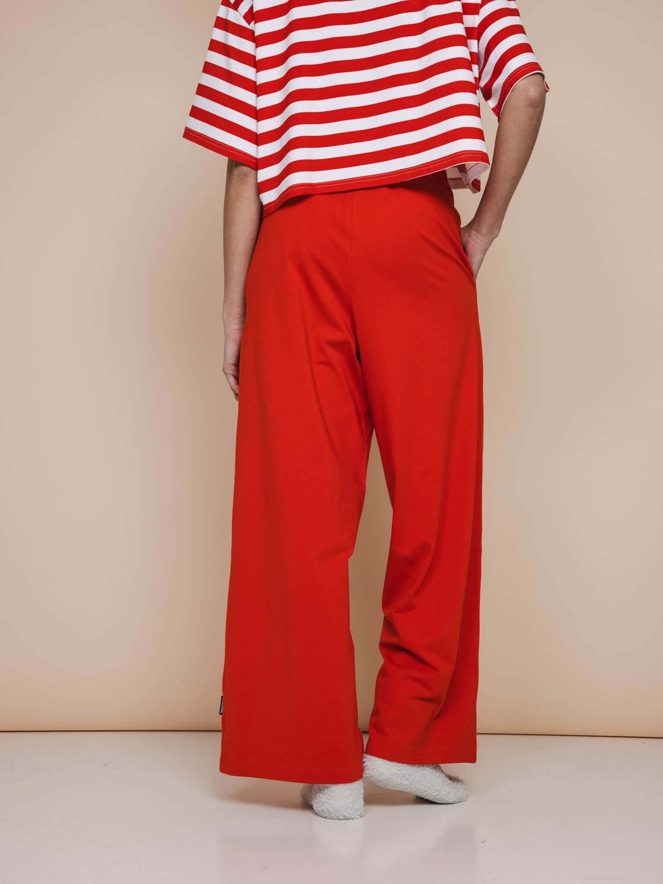 Vrouw in SNURK Red Wijde broek Dames met brede pijpen en een gestreept shirt.