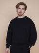 SNURK Slow Black Sweater Heren model in zwart met elastische boordjes, perfecte pasvorm voor relaxdagen.