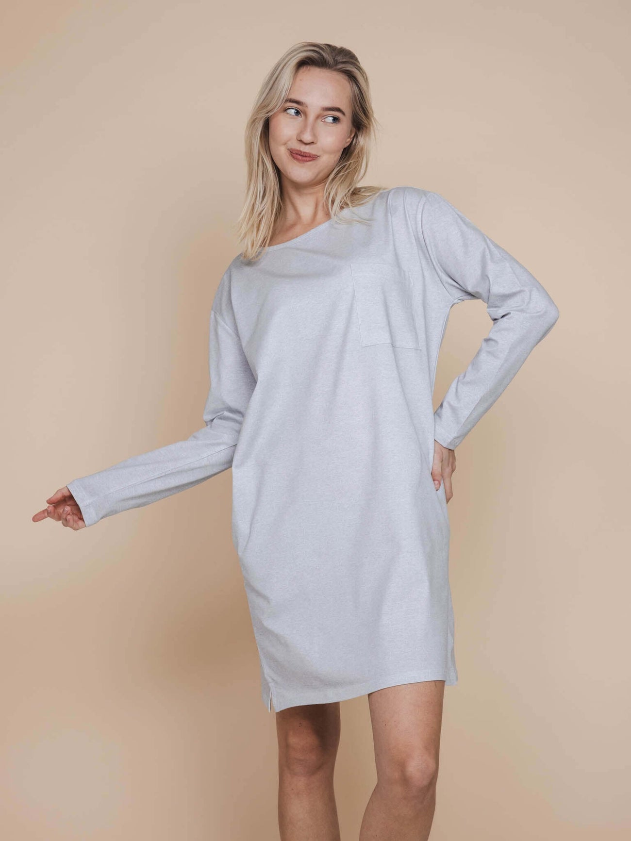 SNURK Slow Grey Long Sleeve Dress Dames model in een lichtgrijs T-shirt jurkje met lange mouwen.