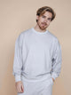 SNURK Slow Grey Sweater Heren model in zachte biologische katoen met opschrift SLOW ON PURPOSE.